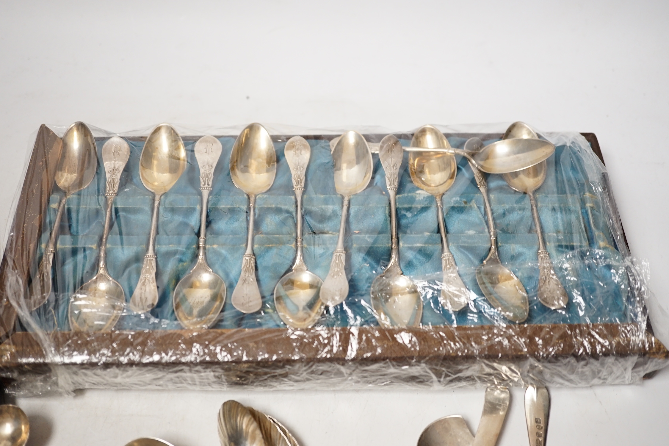 A group of assorted mainly small silver flatware, including 19th century, a small group of sterling spoons, a silver napkin ring and cased silver christening spoon and fork, etc.